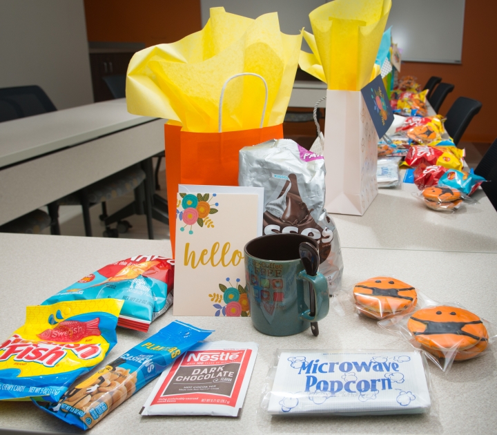 Carol DeNysschen assembles gift bags lined up on table
