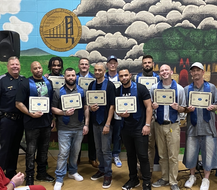 HARP graduates display their certificates.