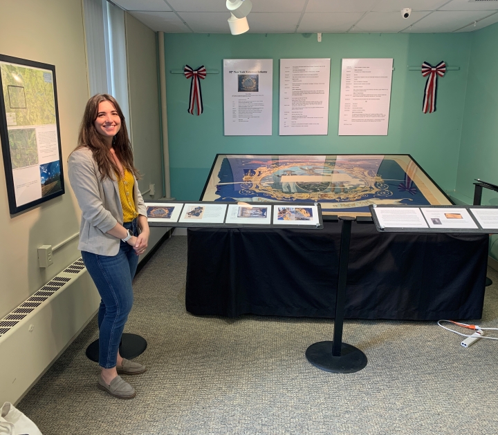 Katya Zinsli standing in front of the flag