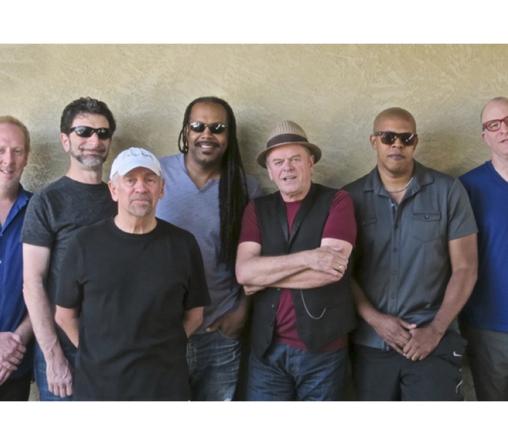 Seven members of the band posing for the camera