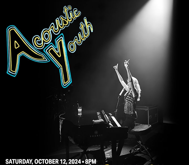 Poster for Debbie Gibson showing her seated at the piano with both arms raised in the air