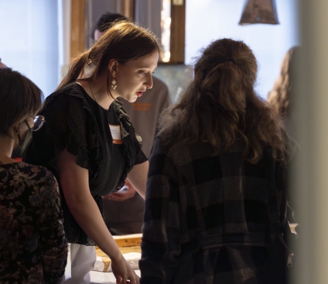 Art Conservation student demonstrates work in progress for visitors