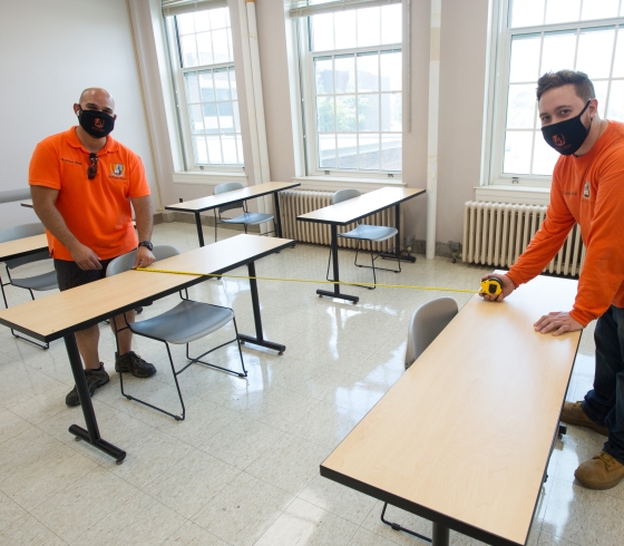 Staff arranging new furniture layout in classrooms