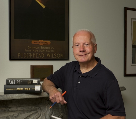Tom Reigstad leaning on the Mark Twain mantelpiece in Butler Library