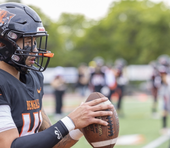 Male football player holding football