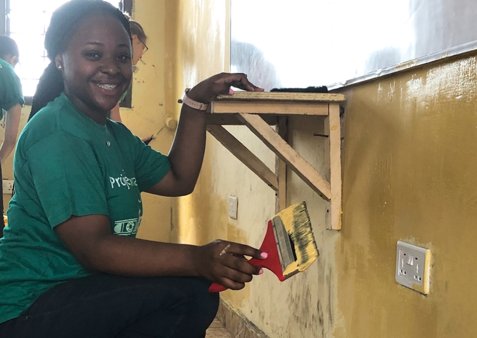 Bryanna Marshall painting a wall