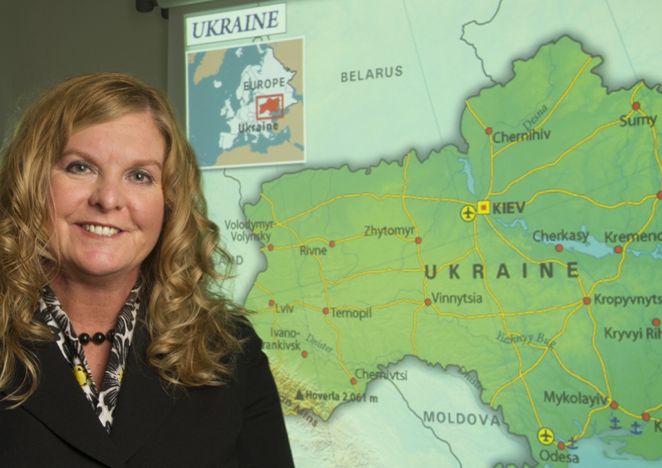 Kimberly Kline standing in front of a map of Ukraine