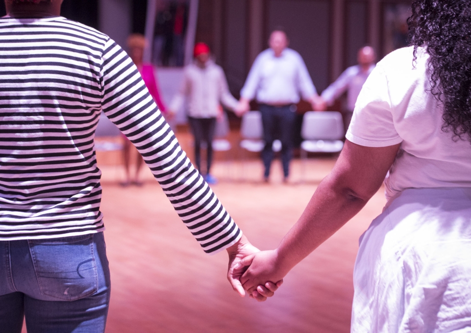 Students in a circle holding hands