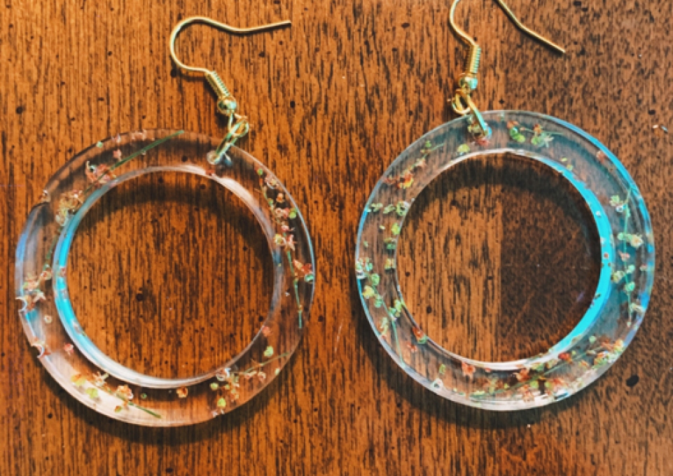 Pair of handcrafted earrings on a table