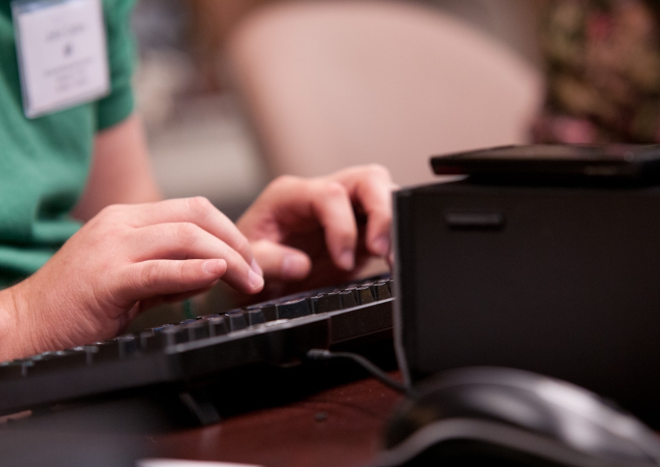 Hands typing on a keyboard