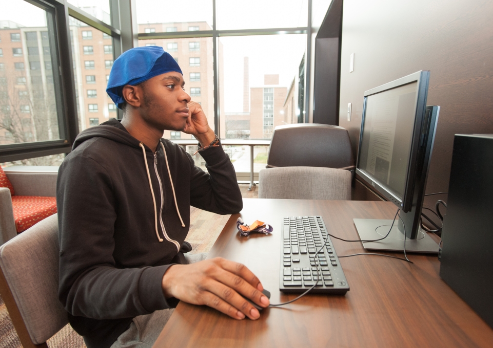 male student working on the computer