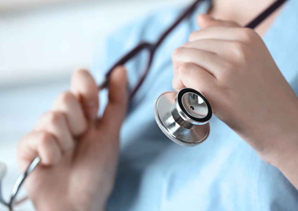 Close up of a stethoscope around the neck of a health-care worker