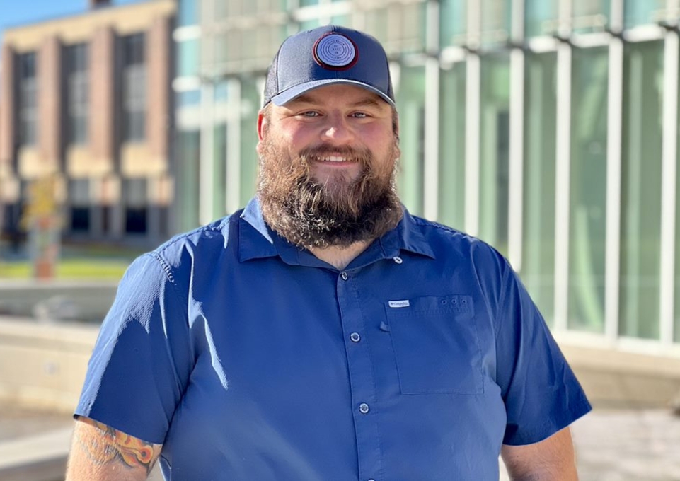 Cody Crist standing in front of the Science and Mathematics Complex