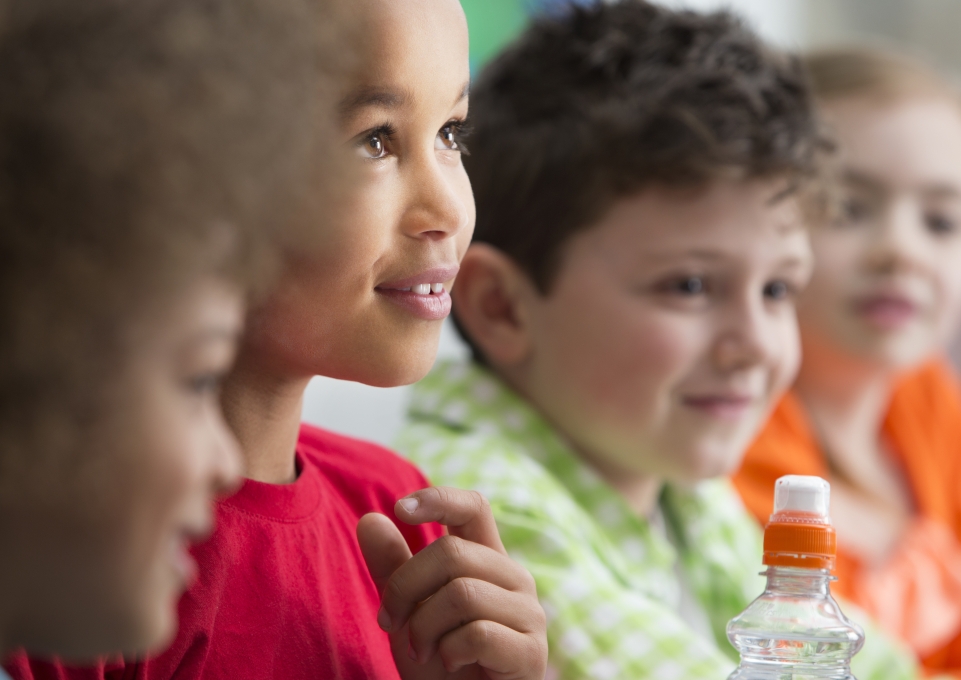 Faces of four smiling children