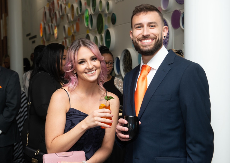Two smiling students holding drinks at the 2022 Bengala