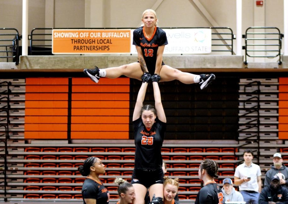 Buffalo State acrobatics and tumbling athletes in formation on the court