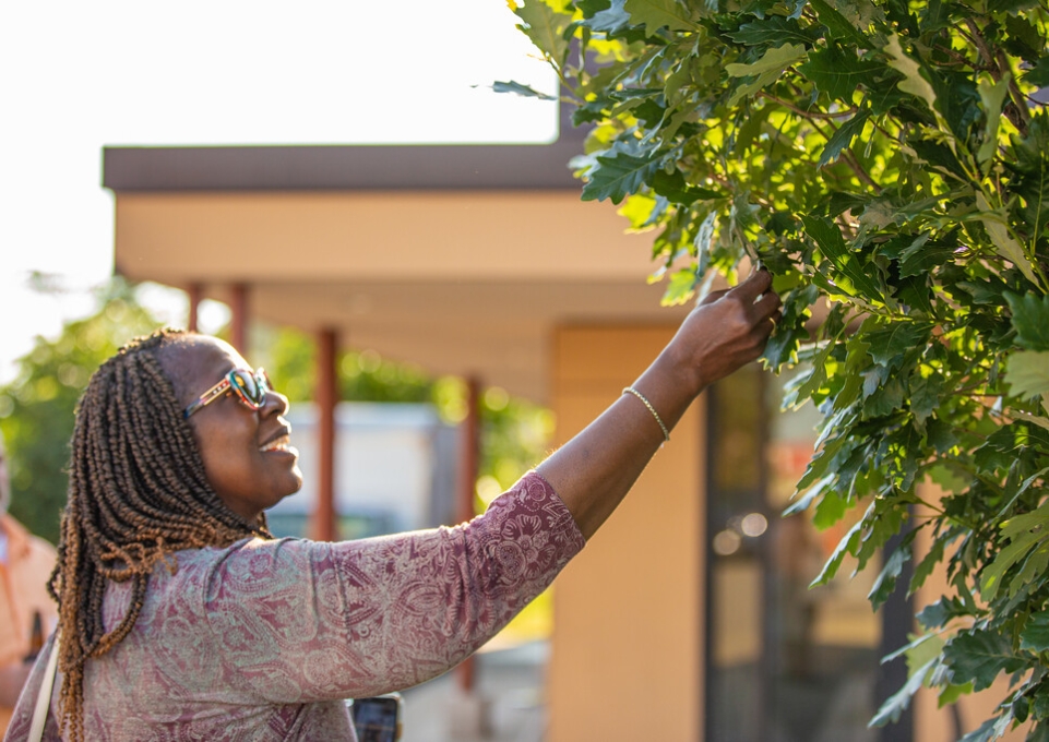 A woman touching a tree