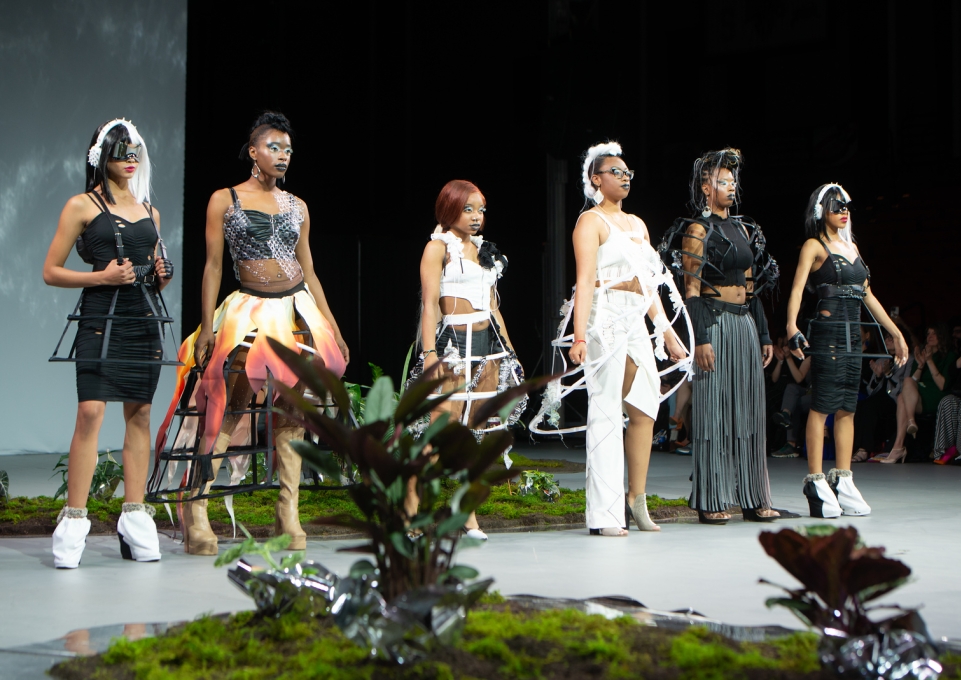 A group of models pose on a stage