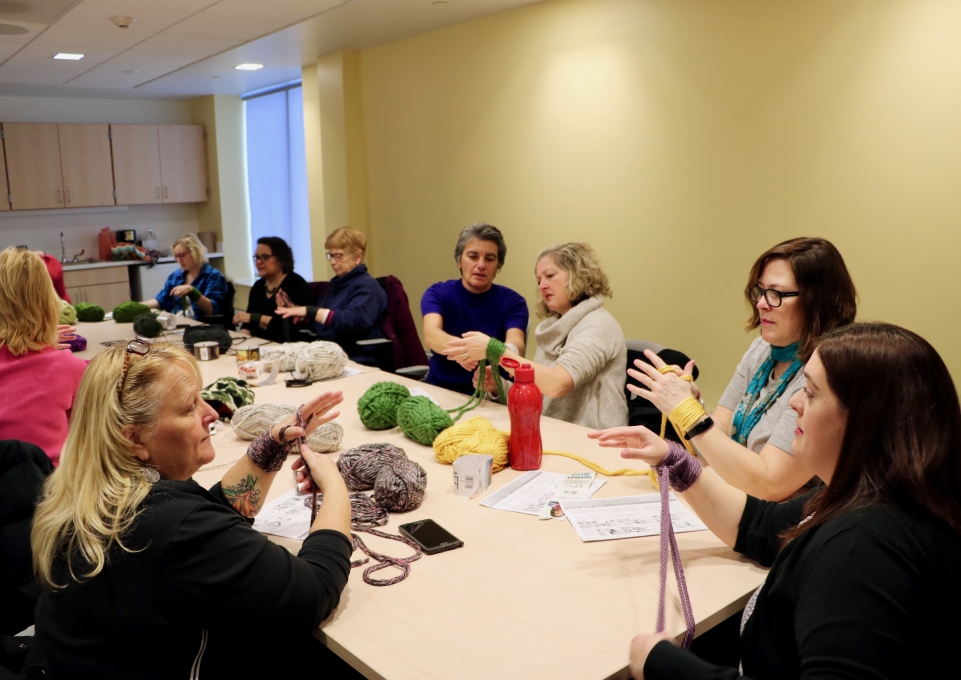 A group of people learn to knit