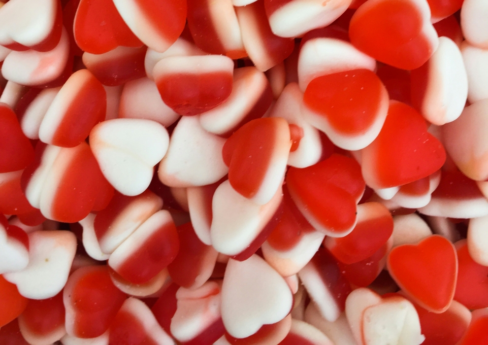A collection of gummy red candy hearts