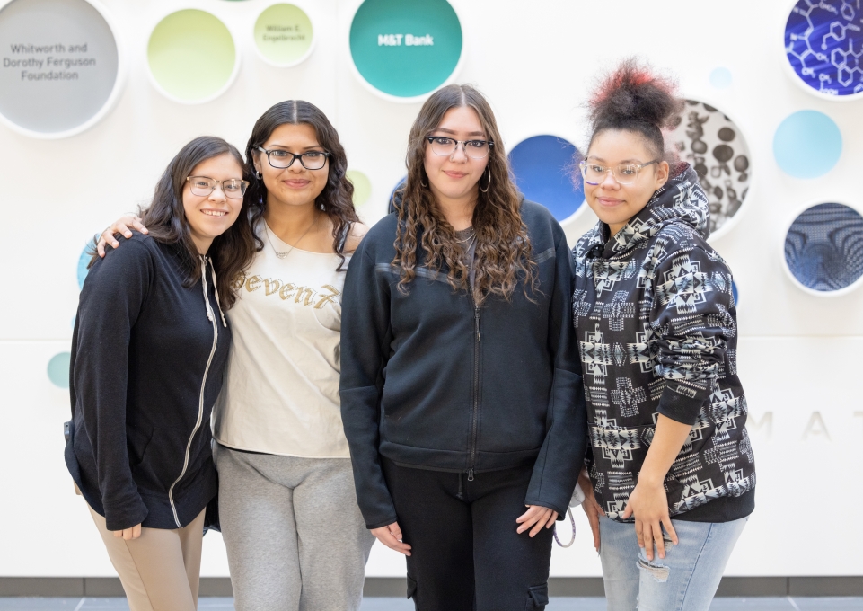 Four female students stand in SAMC